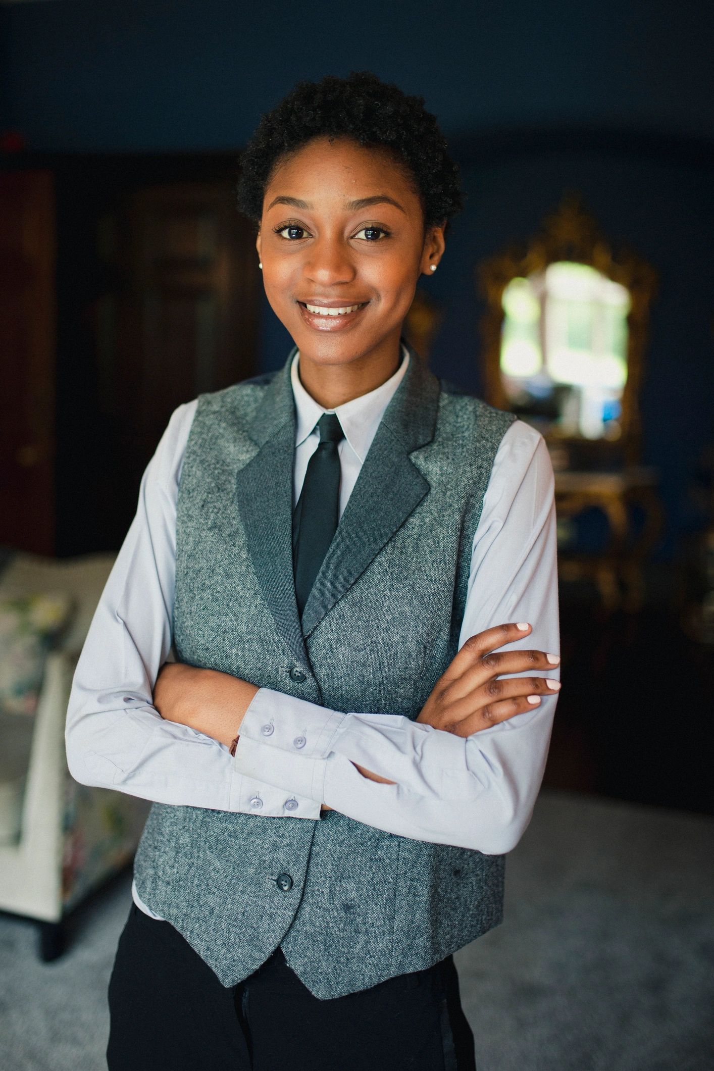 Hospitality staff member smiling in uniform