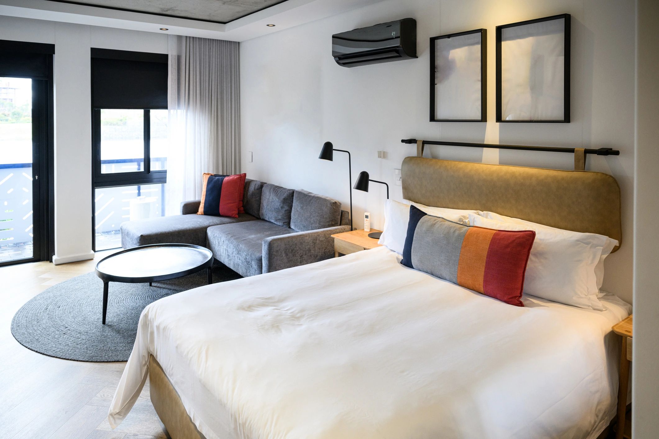 Contemporary hotel room with king bed and warm minimalist design
