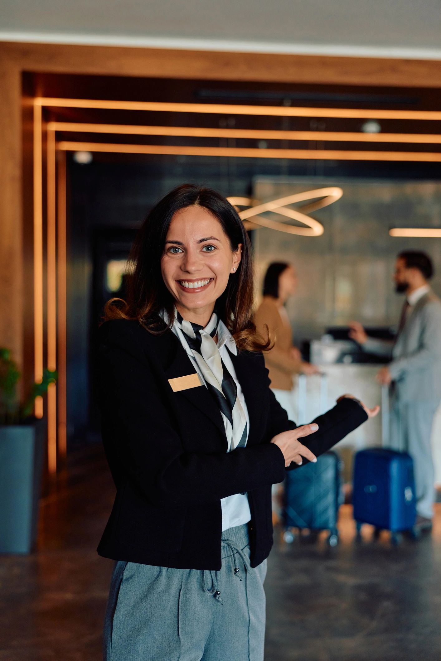 Hotel receptionist welcoming guests at the front desk